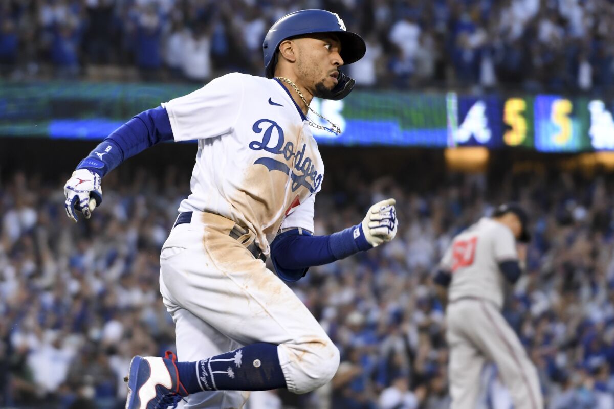 Dodgers' Mookie Betts, left, rounds first after hitting the go-ahead RBI double.