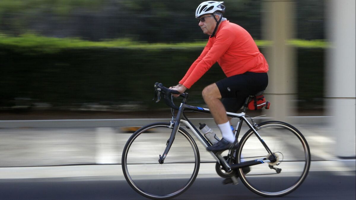Dr. Daniel Marks, 78, taking one of his 22 bicycles out for a spin in his Carlsbad neighborhood.