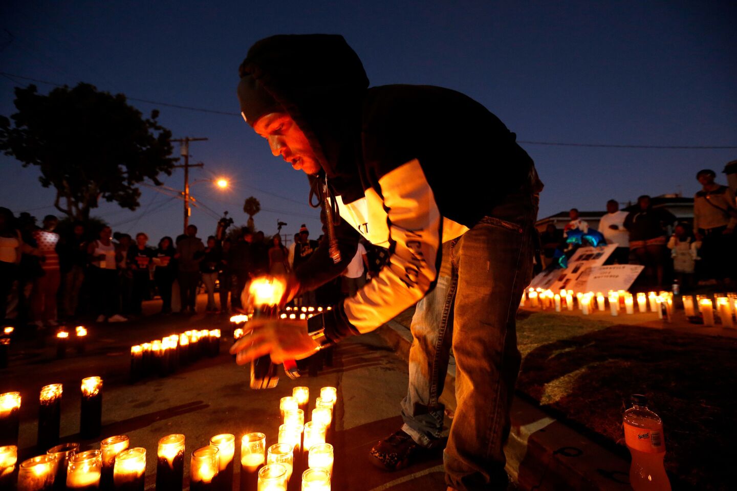 Jeromy Jackson lights candles at a vigil for his friend Carnell Snell Jr., 18, who was fatally shot by LAPD police Saturday after a vehicle pursuit.