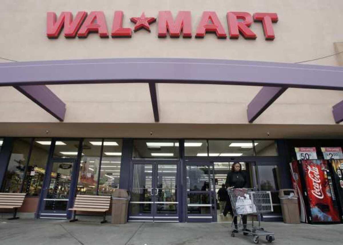 A customer leaves a Wal-Mart store in Mountain View, Calif. The California Legislature is close to passing a bill to raise the minimum wage for workers by $2 an hour over two years.