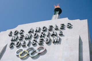 The torch is lit at the Los Angeles Memorial Coliseum, a venue set to host 2028 Olympic events. 