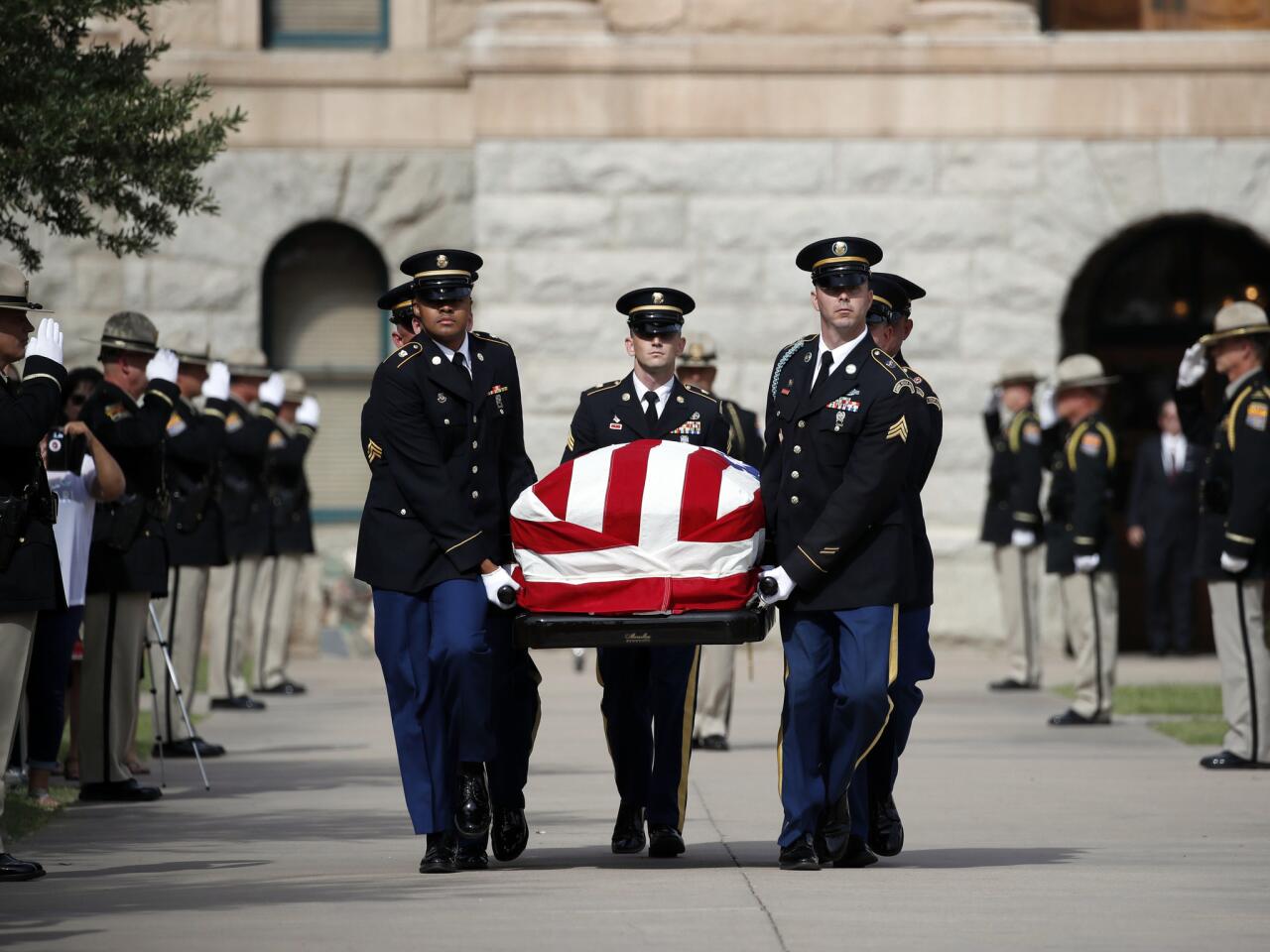 Members of the Arizona National Guard carry the casket of Sen. John McCain (R-Ariz.) from the Arizona Capitol as it heads to the North Phoenix Baptist Church for a memorial service.