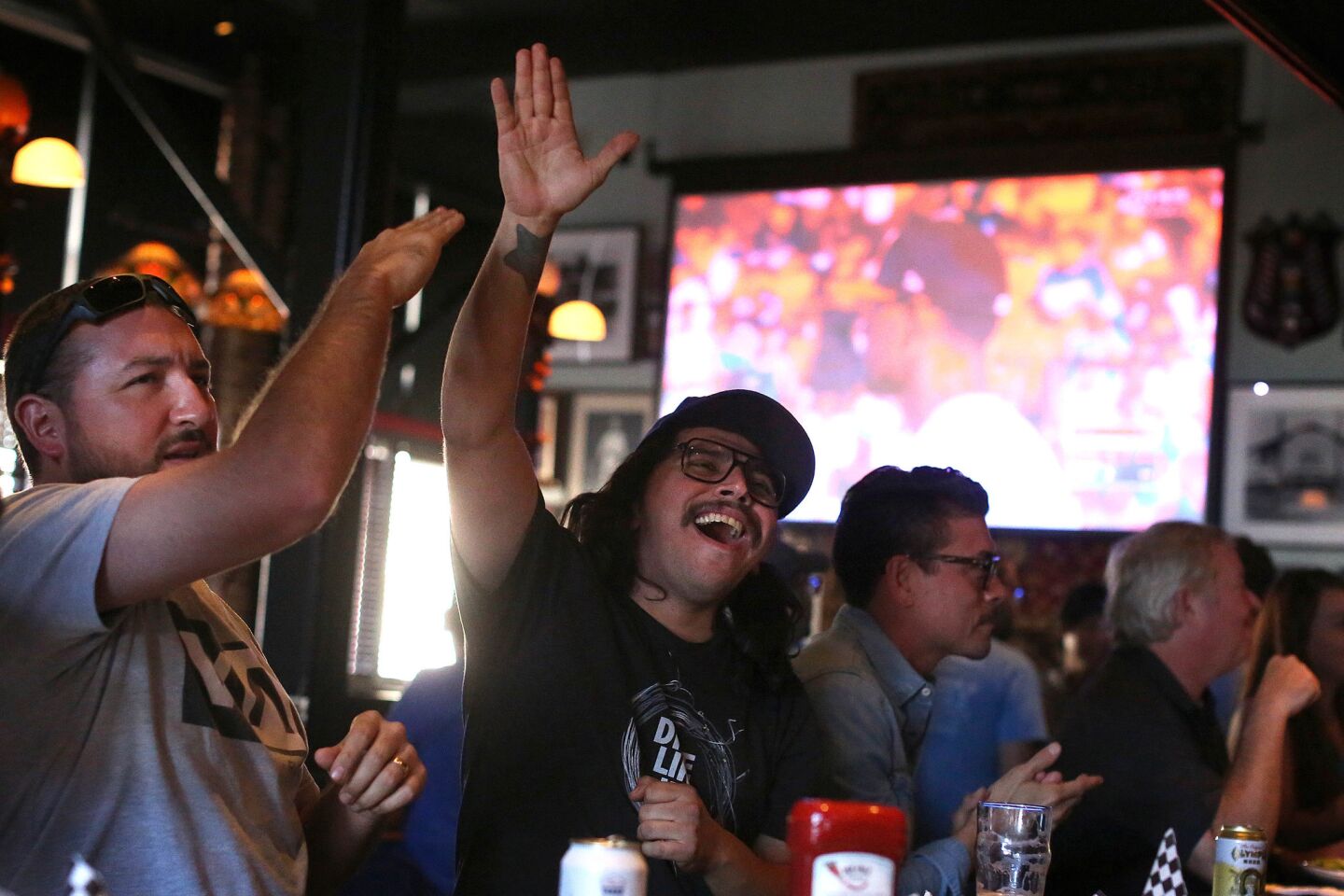 George Montejano, 33, of South Pasadena, and Jorge Pallares, 35, of Eagle Rock, cheer on the home team.