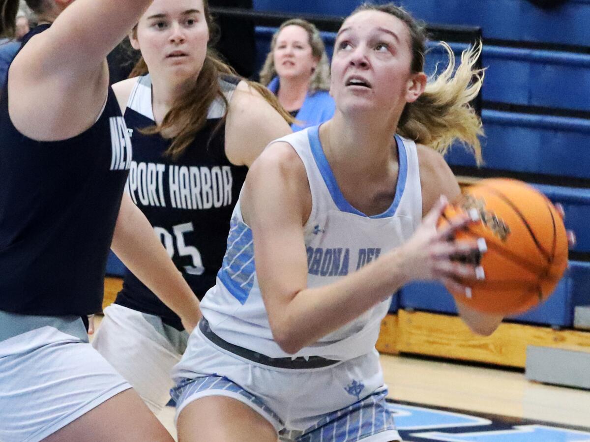 Corona del Mar's Ally Fagella (3) shoots from under the basket against Newport Harbor on Saturday.