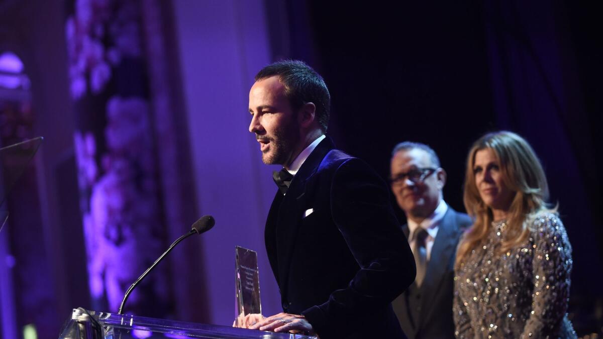 Tom Ford accepts the Courage Award from honorary co-chairs Rita Wilson and Tom Hanks during the Women's Cancer Research Foundation's An Unforgettable Evening on Feb. 16.