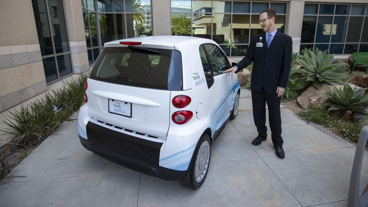 Mark Glavinic, Hoag Hospital's director of rehabilitation, shows how a Smart car is used to help patients with their daily routines as part of the new Fudge Family Acute Rehabilitation Center.
