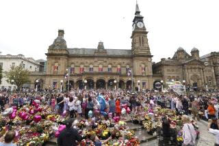 FILE - Members of the public gather outside the Town Hall in Southport, England, Aug. 5, 2024, during a vigil for the victims of the stabbing attack last Monday. (AP Photo/Darren Staples, File)