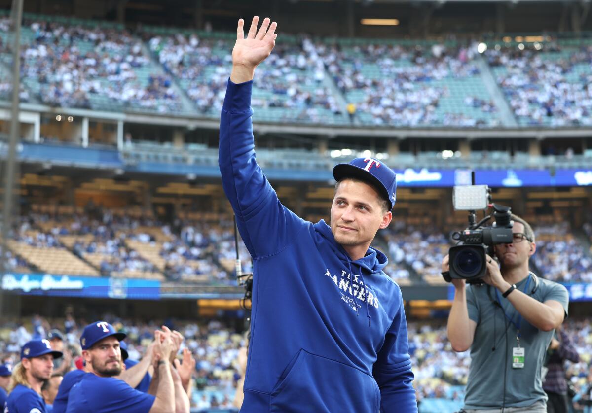 The Rangers' Corey Seager waves to fans after being acknowledged by the public address announcer at Dodger Stadium 