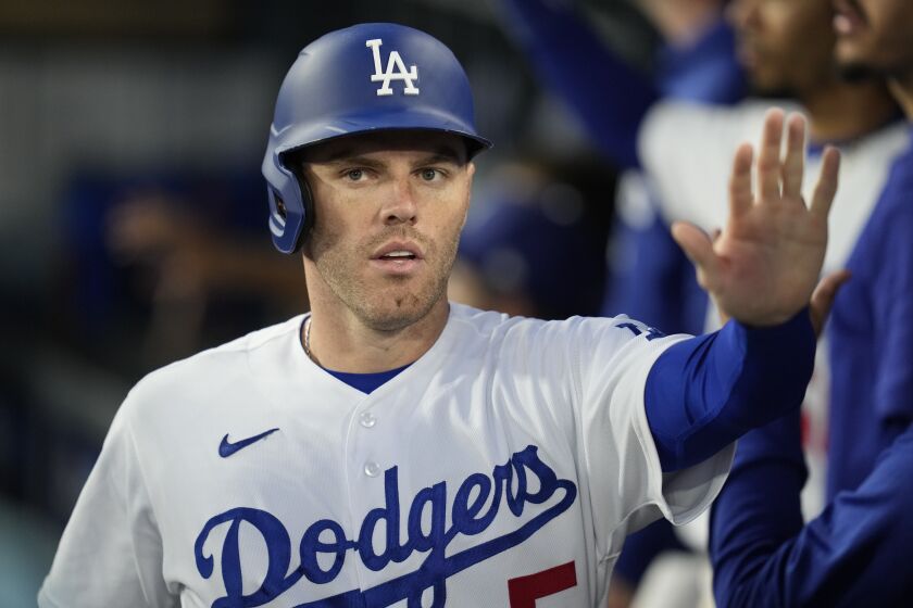 Los Angeles Dodgers' Freddie Freeman (5) returns to the dugout after scoring off of a sacrifice fly hit by J.D. Martinez during the third inning of a baseball game against the Washington Nationals in Los Angeles, Tuesday, May 30, 2023. (AP Photo/Ashley Landis)
