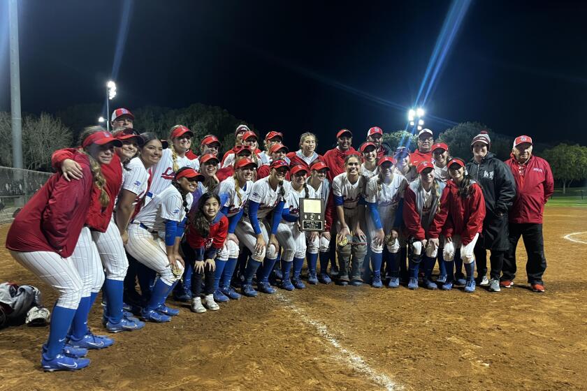 Los Alamitos softball celebrates after winning the Michelle Carew Classic on April 1, 2023.