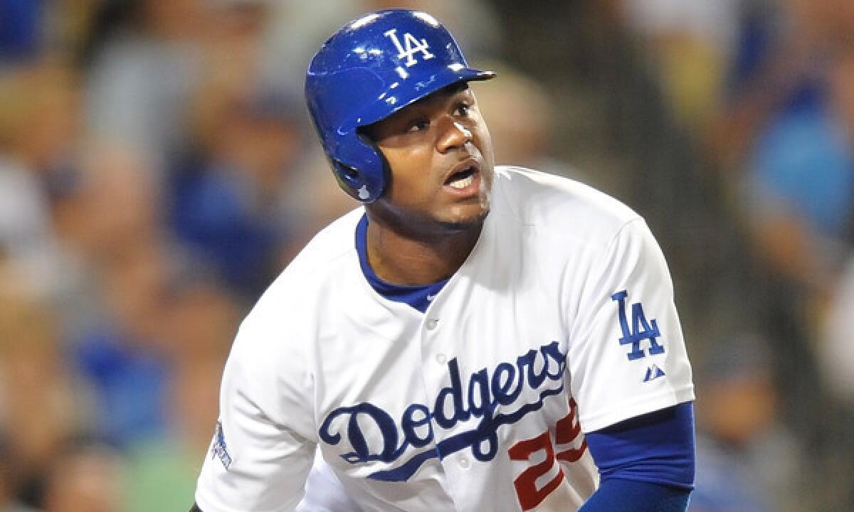 Dodgers outfielder Carl Crawford hits a home run against the Atlanta Braves in Game 4 of the National League division series on Oct. 7. Crawford suffered a shoulder injury in a minor league game on Tuesday.