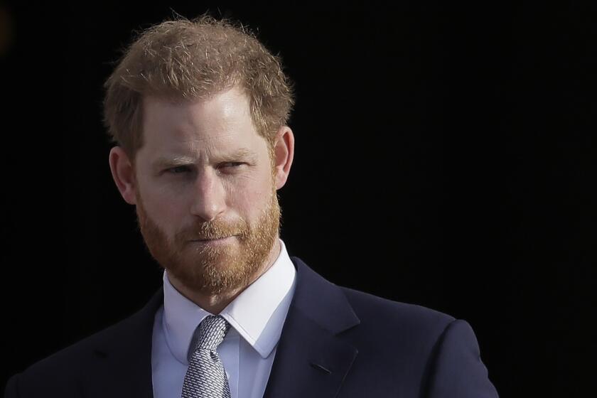 Prince Harry wearing a blue suit and gray tie