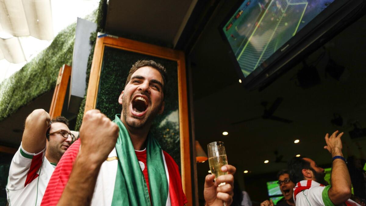 Amir Ardalan Razi celebrates as Iran scored during the last minute of the game.