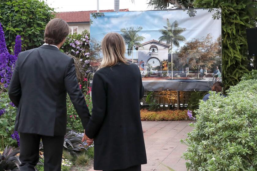 Ashley and Blake Brewer pause to look at an artist rendering of the planned new entrance to Sherman Library & Gardens during the "Grow the Gardens" opening kick-off campaign event at the Sherman Gardens on Thrursday evening in Newport Beach.