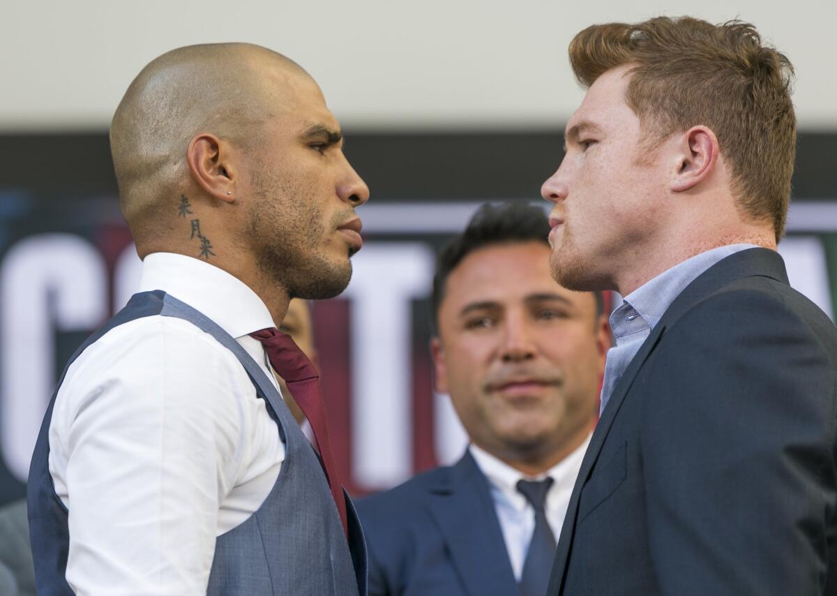 Boxers Miguel Cotto from Puerto Rico, left, and Saul "Canelo" Alvarez from Mexico face each other in Los Angeles on Aug. 24.