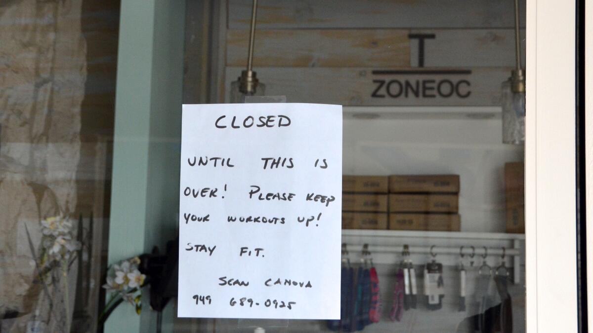 A message from Sean Canova, owner of Training Zone in Costa Mesa, tells customers the gym is closed because of restrictions on nonessential businesses during the coronavirus crisis.