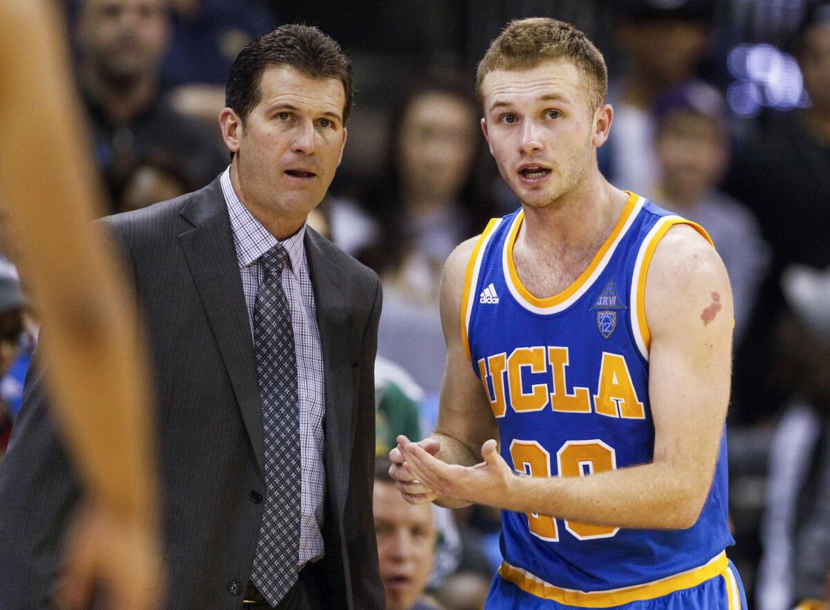 UCLA Coach Steve Alford speaks with guard Bryce Alford (20) during the second overtime in a loss to Washington.