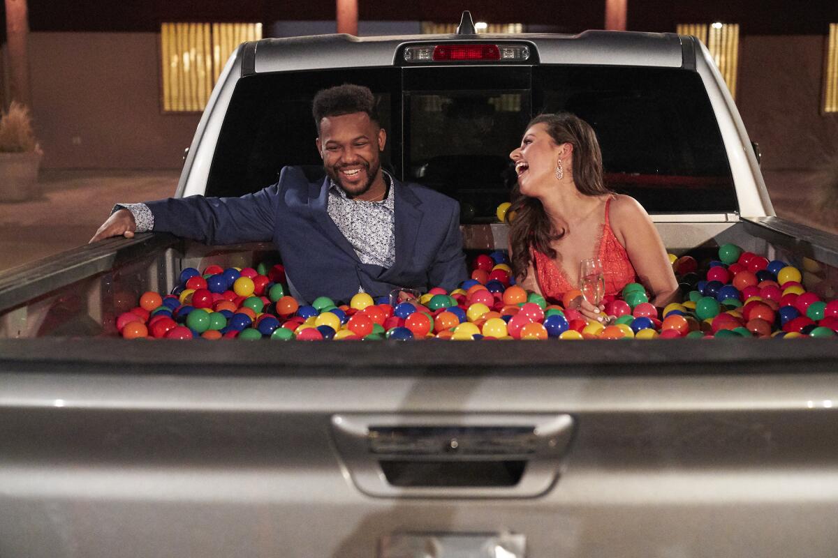 Suitor Tre and Bachelorette Katie Thurston in a truck bed filled with colored balls