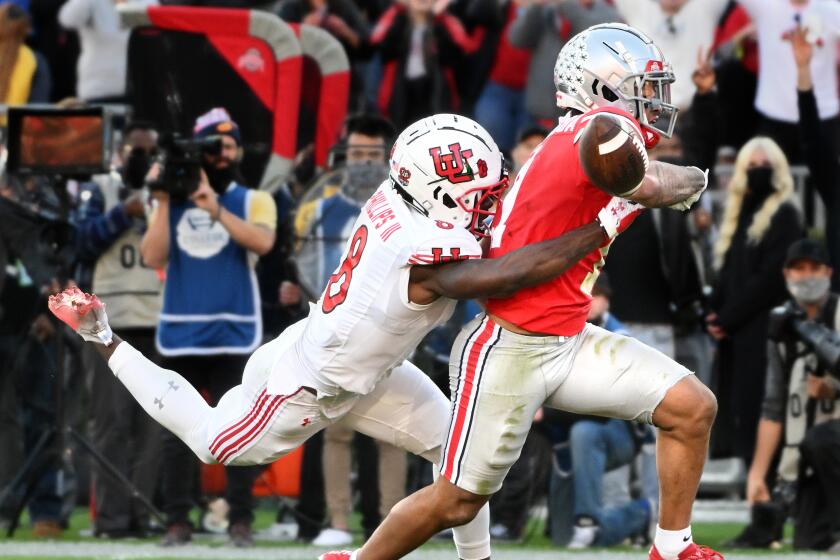 Utah cornerback Clark Phillips strips the ball away from Ohio State wide receiver Jaxon Smith-Njigba in the 2022 Rose Bowl.