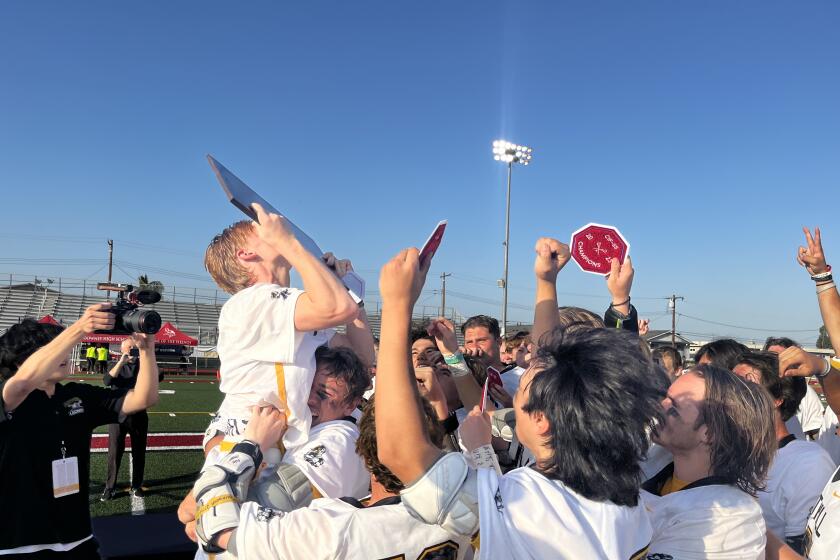 Foothill's Luke Fox kisses the trophy after the Knights beat Loyola for the Southern Section Division 1 title May 12, 2023.