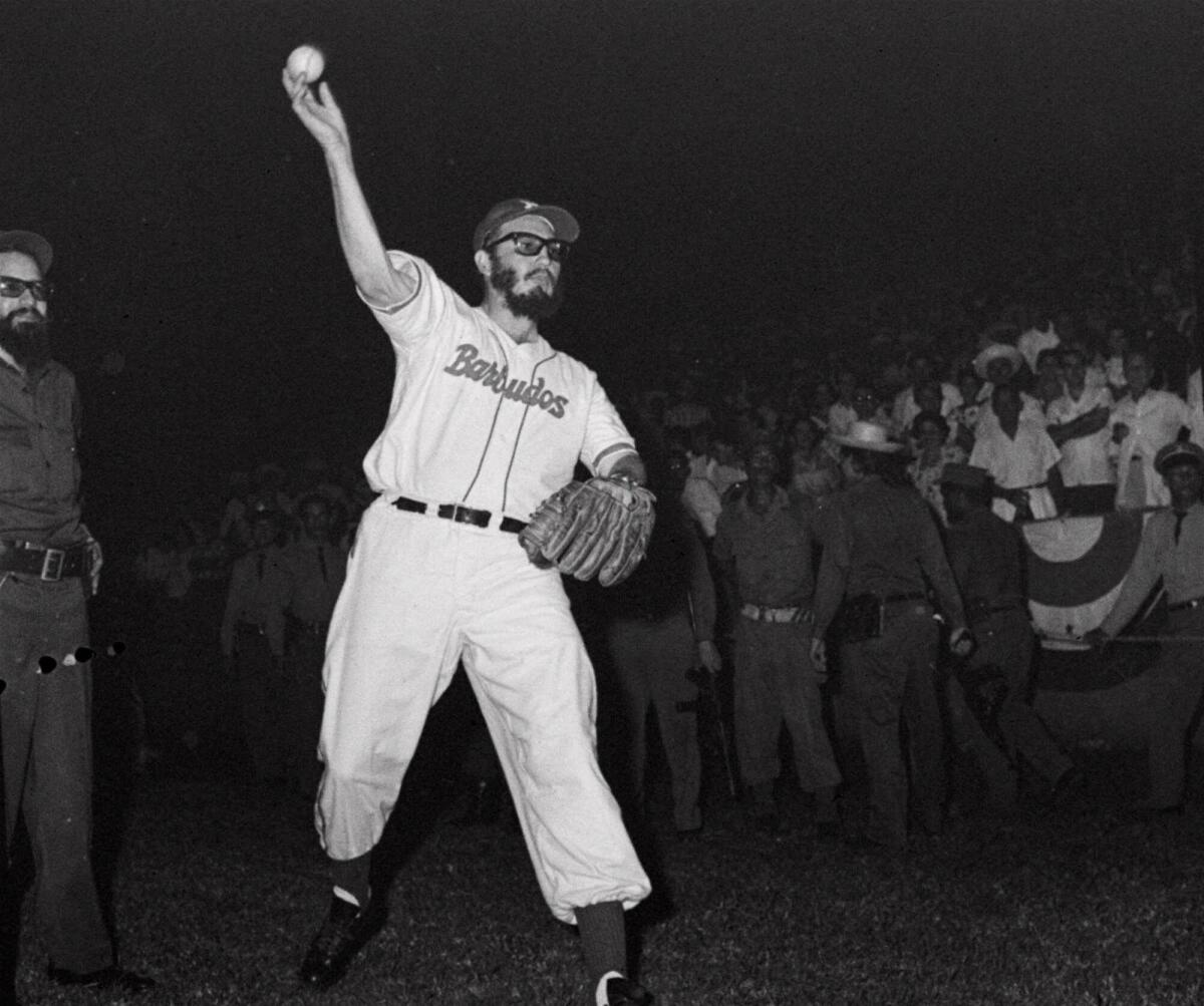 Fidel Castro throws a baseball before the start of a game between the Cuban military and the police on July 24, 1959. (Associated Press)