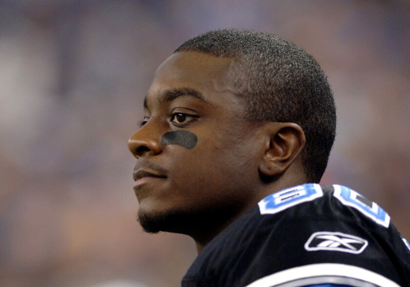 Detroit Lions wide receiver Charles Rogers watches play.