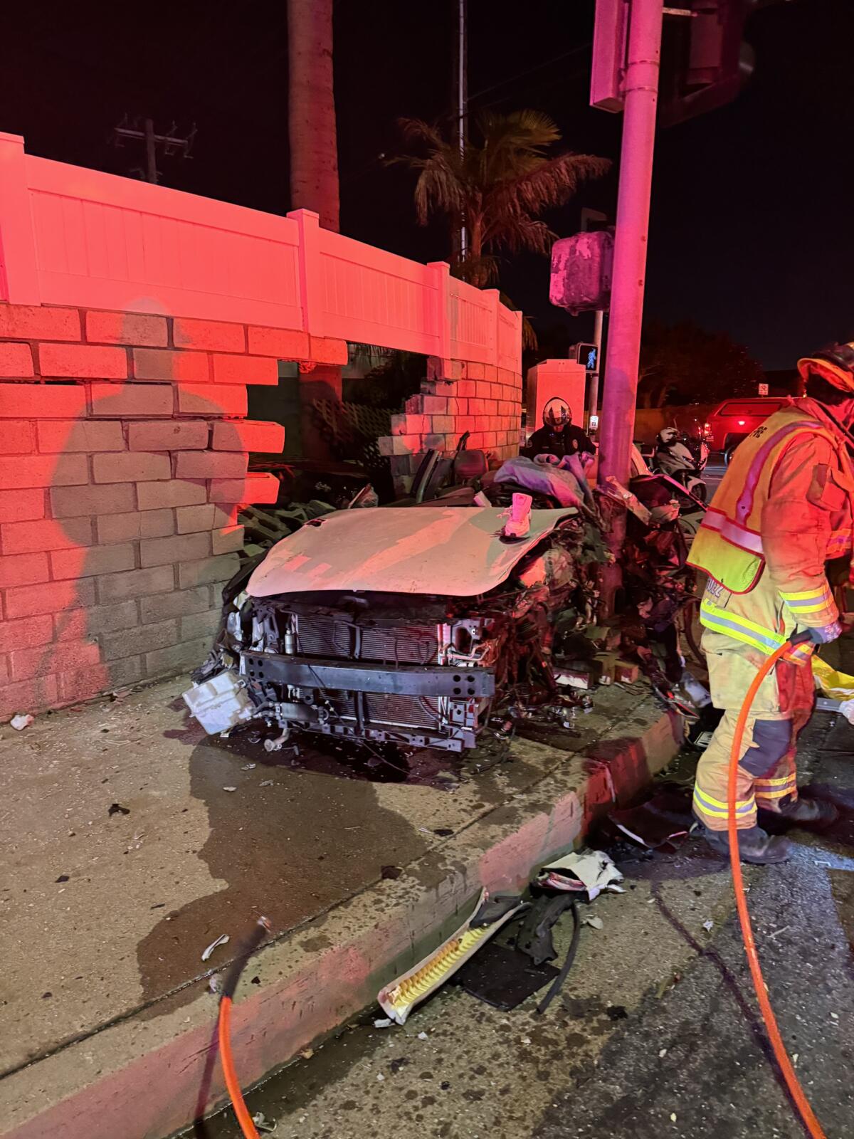 The car involved single-car collision Friday night in Huntington Beach became wedged between a wall and a light pole.