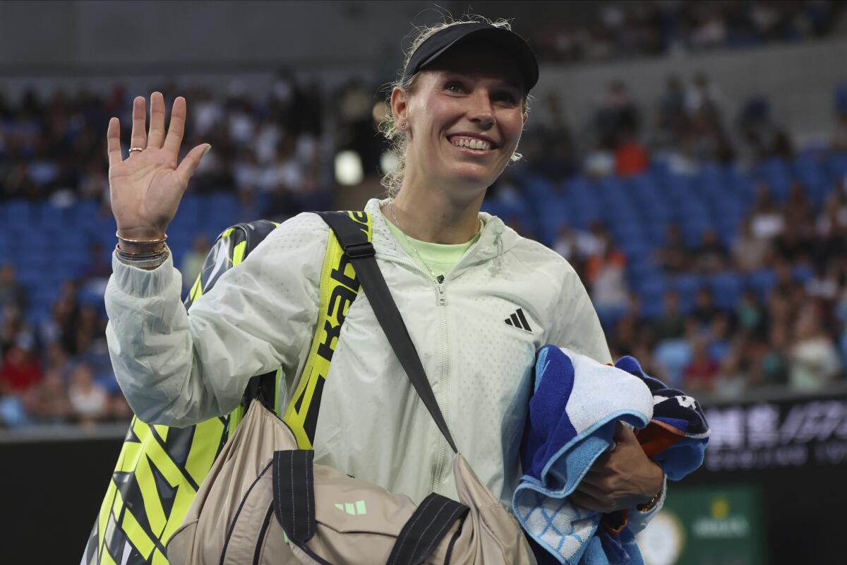Caroline Wozniacki of Denmark waves as she leaves the court after winning her first round match against Magda Linette of Poland at the Australian Open tennis championships at Melbourne Park, Melbourne, Australia, Sunday, Jan. 14, 2024. (AP Photo/Asanka Brendon Ratnayake)