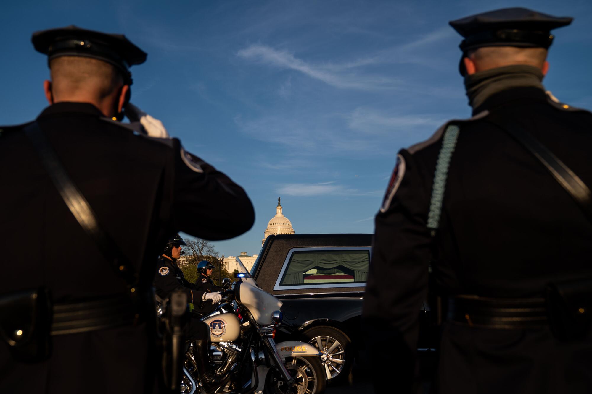 Officers salute a procession hearse carrying Capitol Police Officer William "Billy" Evans.