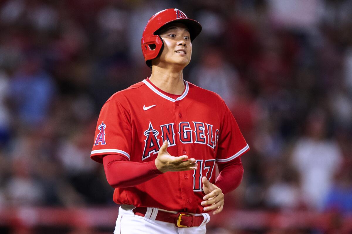 Shohei Ohtani asks for his gloves during the 10th inning of the Angels’ comeback win.