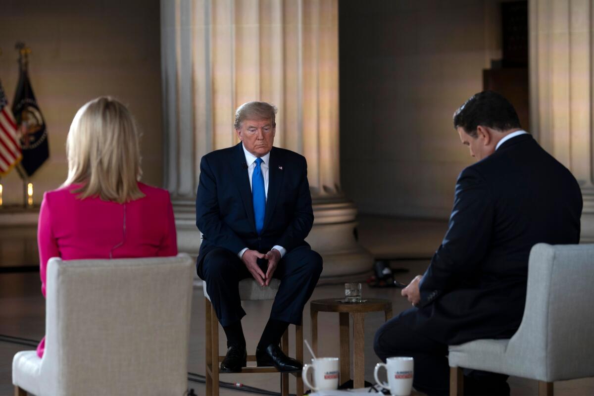 President Trump pauses during a Fox News virtual town hall on Sunday at the Lincoln Memorial in Washington. 