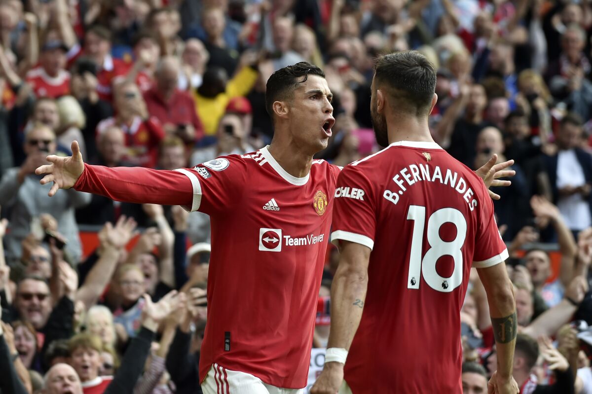Manchester United's Cristiano Ronaldo celebrates after scoring the opening goal during the English Premier League soccer match between Manchester United and Newcastle United at Old Trafford stadium in Manchester, England, Saturday, Sept. 11, 2021. (AP Photo/Rui Vieira)