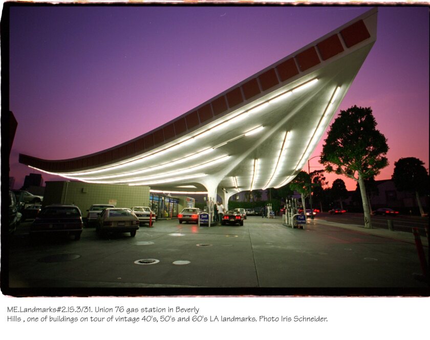 A plunging triangle shape covers pumps at a Beverly Hills gas station at sunset