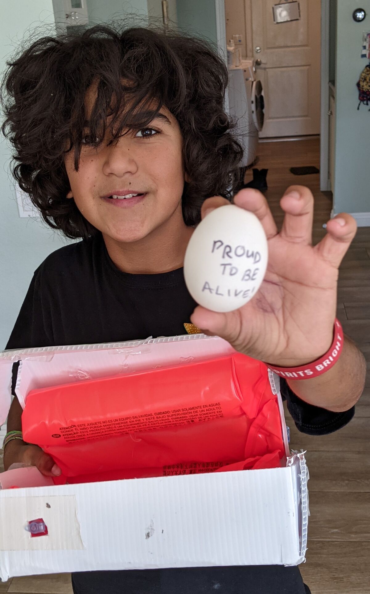 Milan proving the innovation project worked by mailing an egg across San Diego.