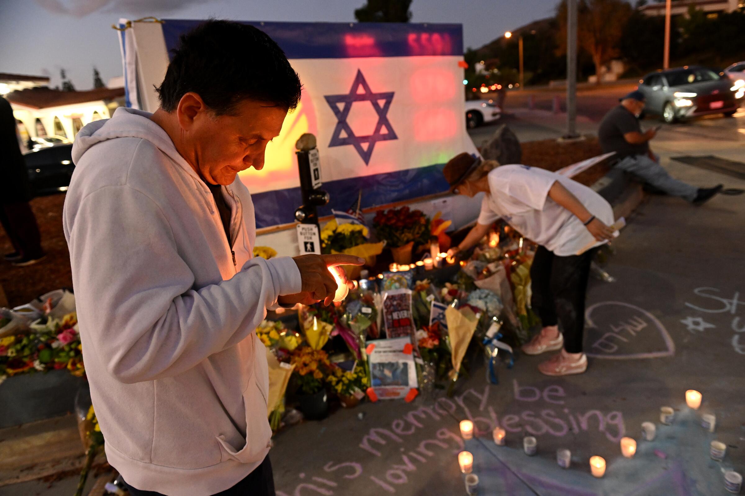 People pay respects at a memorial for Paul Kessler, who died after a confrontation at a protest in Thousand Oaks.
