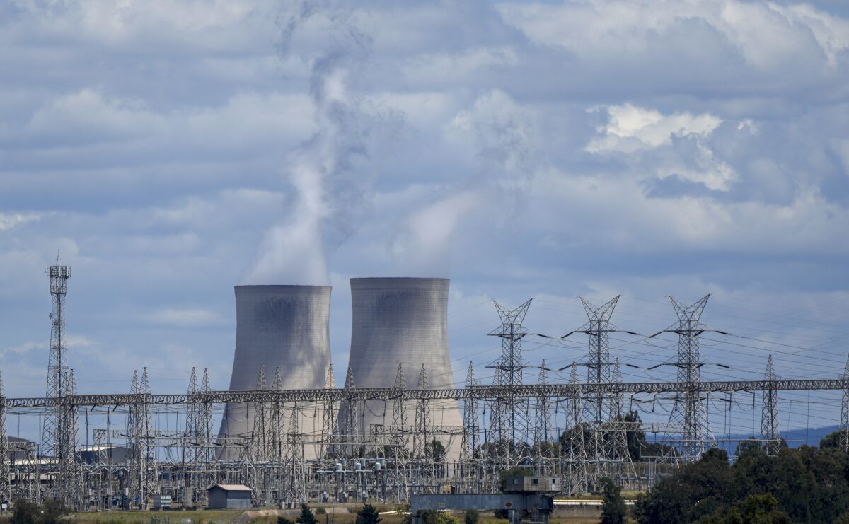 FILE- Bayswater Power Station a coal-powered thermal power station near Muswellbrook in the Hunter Valley, Australia, Tuesday, Nov. 2, 2021. The Australian Parliament has created landmark new laws, Thursday March 30, 2023, that will make the nation's biggest greenhouse gas polluters reduce their emissions or pay for carbon credits. (AP Photo/Mark Baker, File)