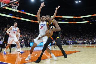 Phoenix Suns forward Kevin Durant backs down Los Angeles Clippers forward Nicolas Batum (33) during the second half of Game 1 of a first-round NBA basketball playoff series, Sunday, April 16, 2023, in Phoenix. (AP Photo/Matt York)