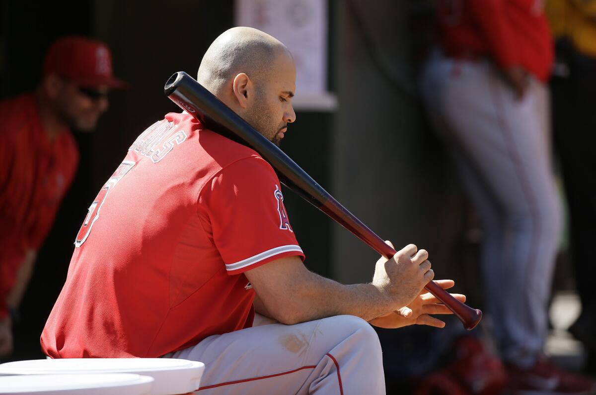 Albert Pujols sits in the dugout during the Angels' game against Oakland on Sept. 2.