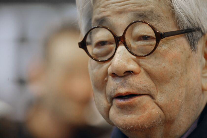 FILE - Japanese Nobel Prize winning author Kenzaburo Oe poses during the inauguration of the 32nd Paris Book Fair, which focused on Japanese writers, March 15, 2012. Japanese publisher Kodansha Ltd. said Monday, March 13, 2023 that Nobel literature laureate Kenzaburo Oe died of old age. Oe's darkly poetic novels were built from a childhood during Japan’s postwar occupation and parenthood with a disabled son. (AP Photo/Jacques Brinon, File)