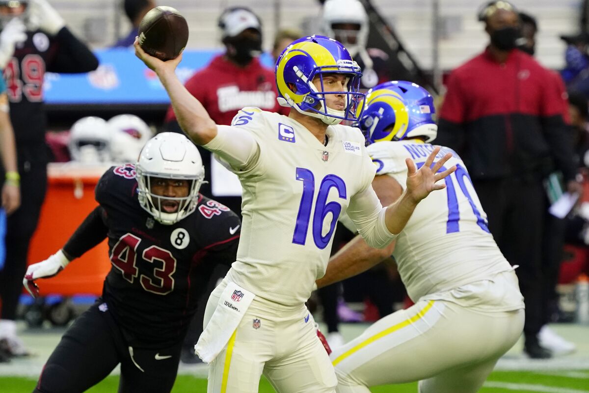 Rams quarterback Jared Goff throws as Arizona Cardinals outside linebacker Haason Reddick pursues.