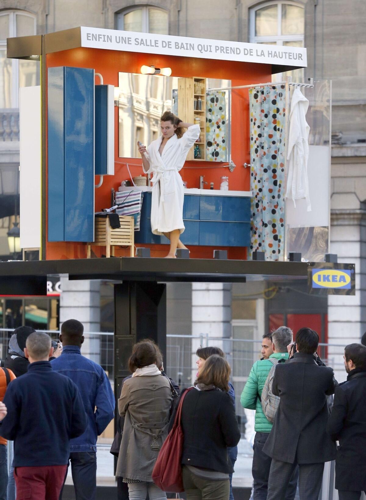 An actress is the star of a live Ikea billboard in front of a Paris train station.