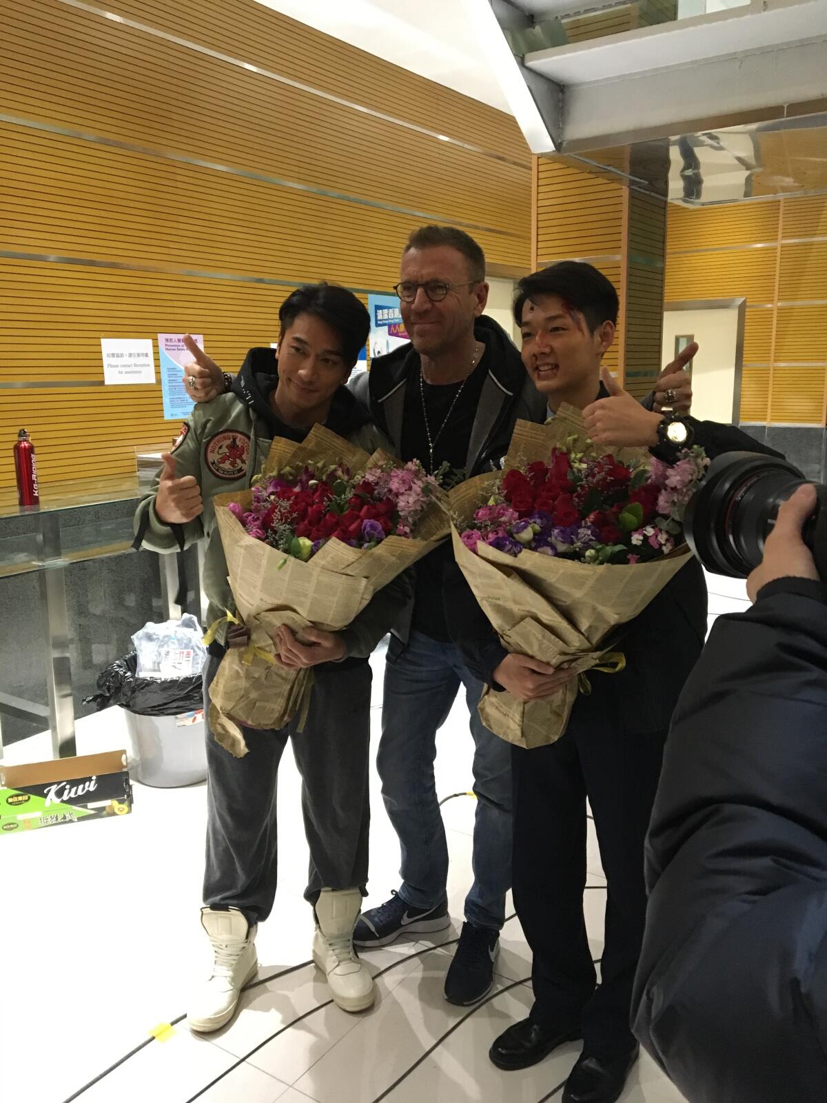 Director Renny Harlin congratulates two actors who had finished filming on his 2019 Chinese action thriller "Bodies at Rest."