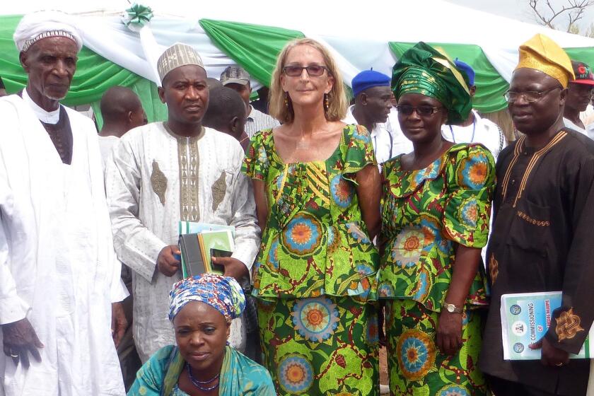 In this undated photo provided by Mike Henry, kidnapped Seattle missionary the Rev. Phyllis Sortor is shown standing at center with a delegation of area dignitaries in a town in Nigeria.