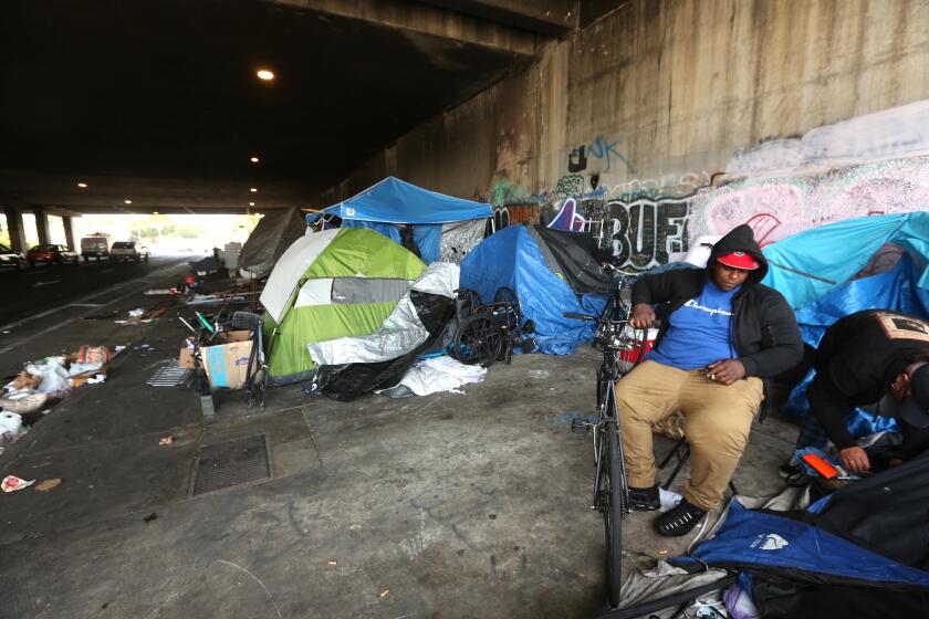 LOS ANGELES, CA - JULY 6, 2023 -"We're not animals," said Dominique Beiard, 33, right, next to his tent in a homeless encampment known as Skid Row West under the 405 freeway overpass along Venice Blvd. in Los Angeles on July 6, 2023. Beiard was referring to conservative members of the U.S. 9th Circuit Court of Appeals who took collective aim Wednesday at the idea that homeless people with nowhere else to go have a right to sleep in public, excoriating their liberal colleagues for ruling as much. "I just want to get up off these streets, Beiard said. (Genaro Molina/Los Angeles Times)