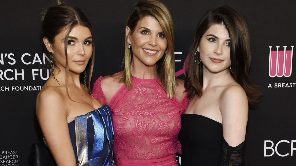 Lori Loughlin with daughters Olivia Jade Giannulli, left, and Isabella Rose Giannull at an event in Beverly Hills on Feb. 28. Loughlin and her husband Mossimo Giannulli were charged along with nearly 50 other people in the college admissions scandal.