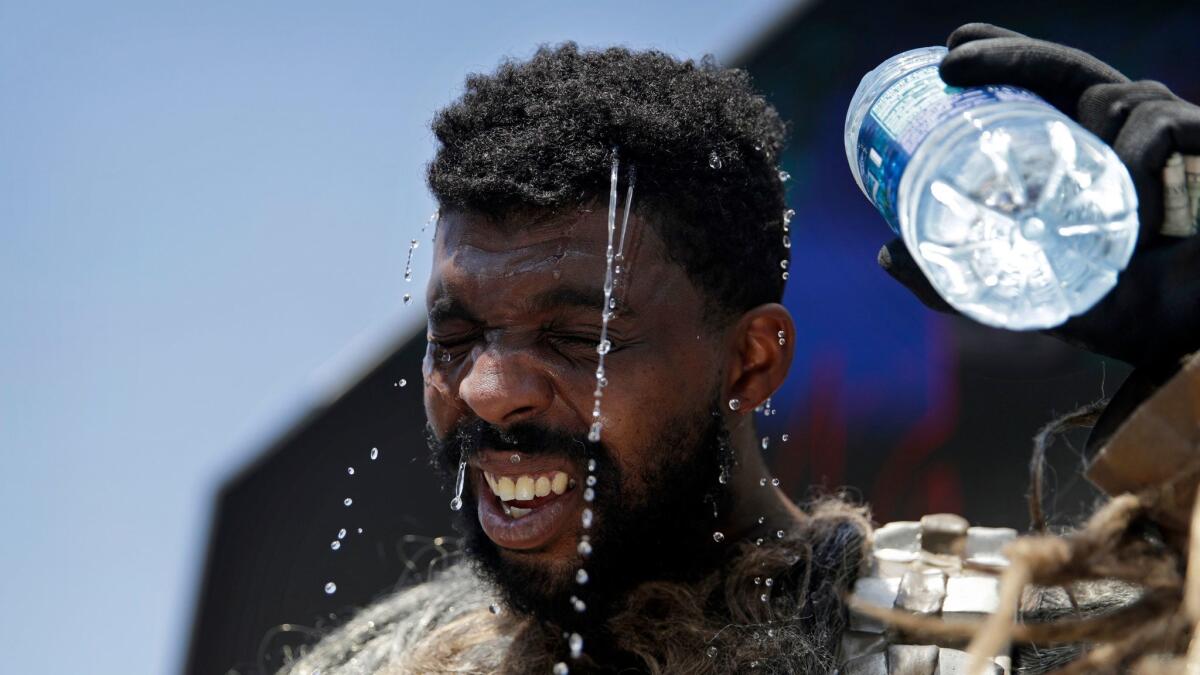 Xaviere Coleman, one of the costumed performers on the Las Vegas Strip, tries to cool off as temperatures skyrocket Tuesday. Coleman, who dresses as a Wookiee, was among a few performers who braved the heat.