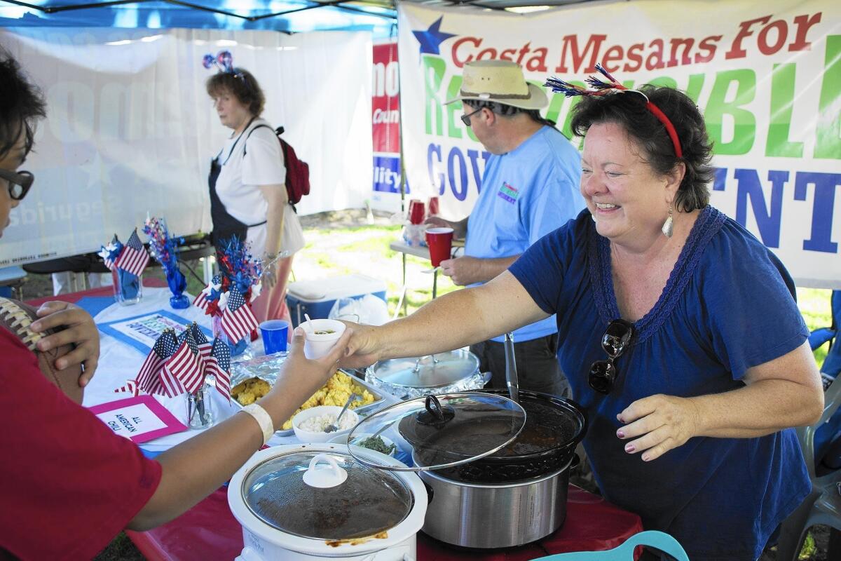 Terri Fuqua with Costa Mesans for Responsible Government hands out pork chili during the 11th annual Halecrest Park Chili Cook-Off on Saturday in Costa Mesa.