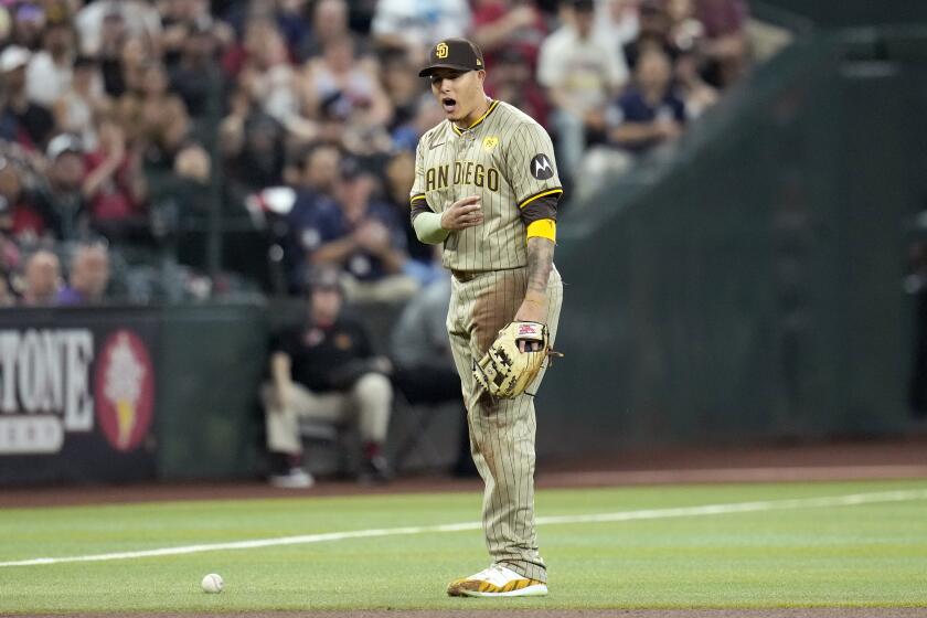 San Diego Padres third baseman Manny Machado shouts as he is unable to make a play on a single by Arizona Diamondbacks' Christian Walker during the fourth inning of a baseball game, Sunday, May 5, 2024, in Phoenix. (AP Photo/Ross D. Franklin)