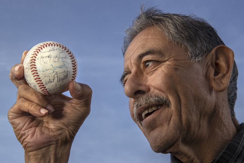 Oxnard, CA - November 18, 2021: Oxnard resident Buddy Salinas, 69, holds a baseball signed by the 1962 Milwaukee Braves, including Denny Lemaster. Salinas who is ill and doesn't think he has long to live, plans to return the ball to Denny Lemaster, a pitcher on that Braves team and the finest pitcher to come out of Oxnard. Salinas was given the ball by a close friend of Lemaster's when Salinas, a plumber by trade, was re-piping the man's Oxnard home more than 20 years ago. (Mel Melcon / Los Angeles Times)