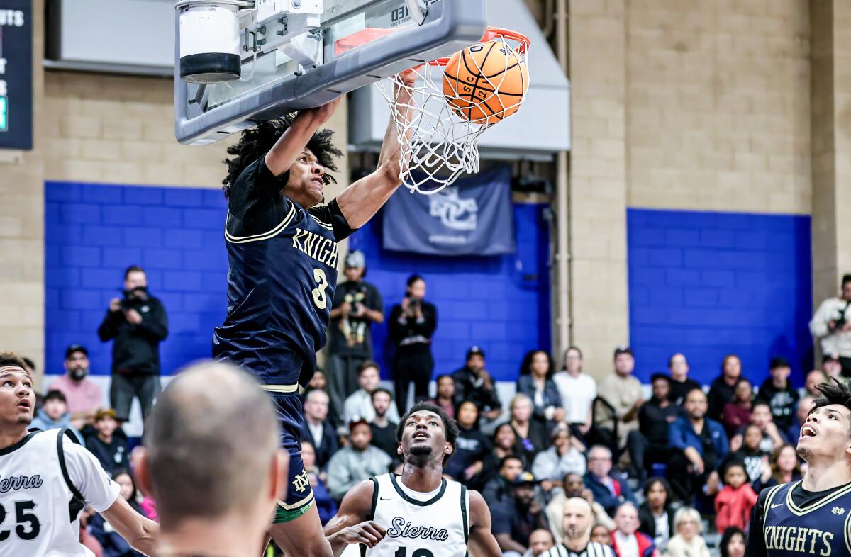 Zachary White of Sherman Oaks Notre Dame delivers a dunk in an 83-72 win over Sierra Canyon.